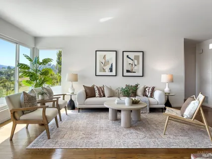 a living room with furniture large window and a table