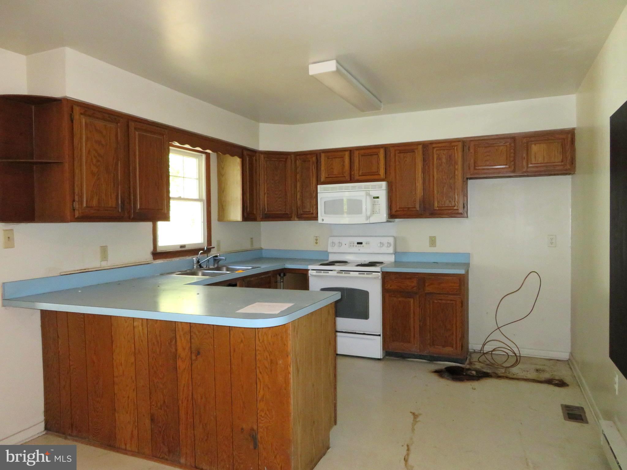 330 Pilot Way Lusby, MD 20657 - Photo 4 of 19 a kitchen with granite countertop a sink stove and cabinets