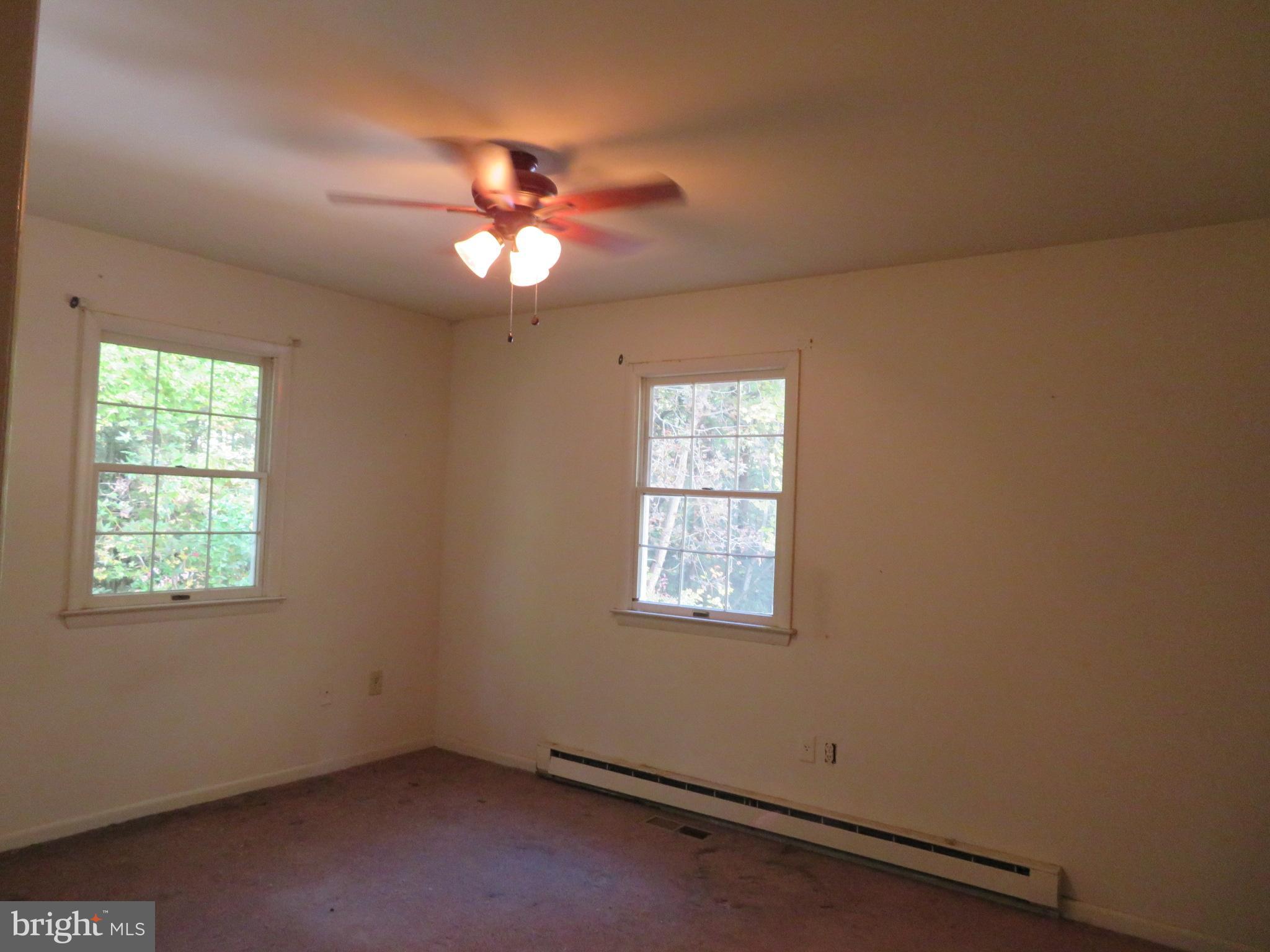 330 Pilot Way Lusby, MD 20657 - Photo 9 of 19 an empty room with windows and fan