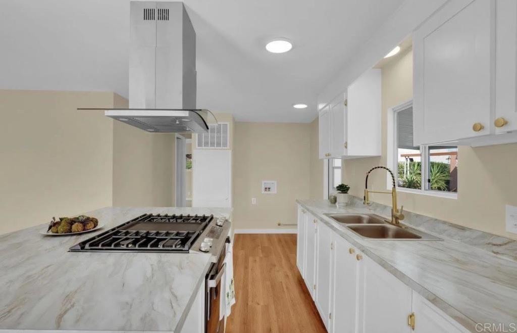 a kitchen with stainless steel appliances a sink a stove and a refrigerator