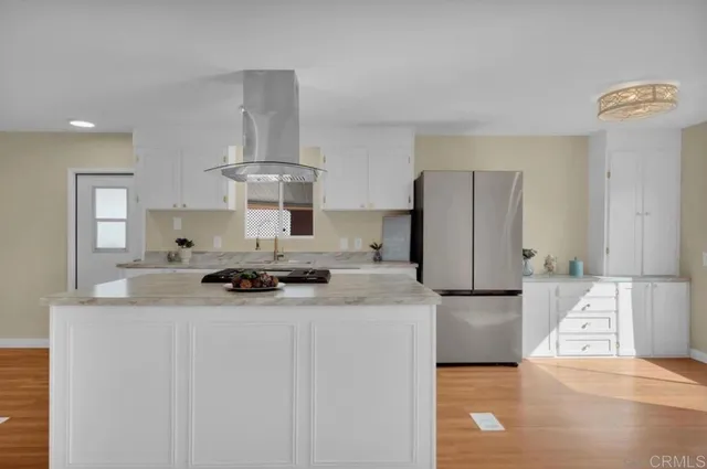 a kitchen with stainless steel appliances a stove refrigerator sink and cabinets