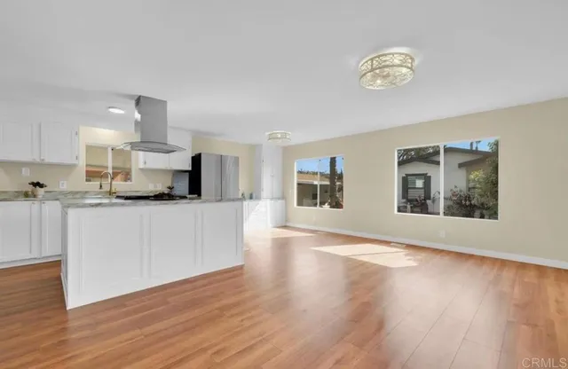 a view of kitchen with wooden floor and electronic appliances