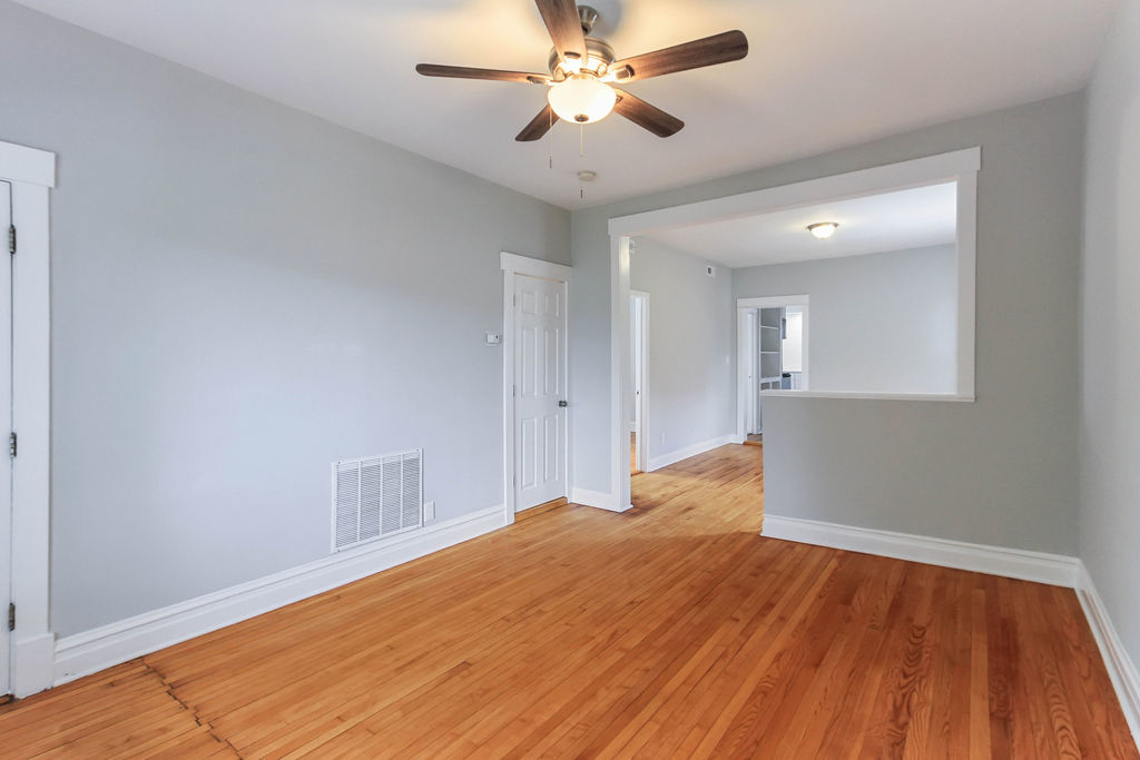 6046 West Giddings Street Chicago, IL 60630 - Photo 16 of 46 a bedroom with a bed and a chandelier fan