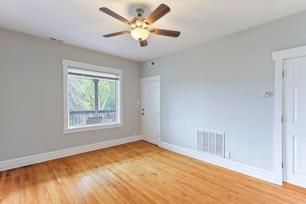 6046 West Giddings Street Chicago, IL 60630 - Photo 17 of 46 a view of an empty room with a window and wooden floor