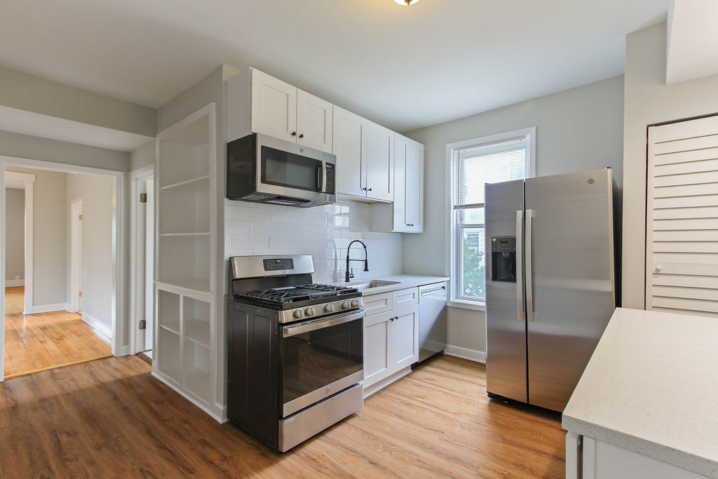 6046 West Giddings Street Chicago, IL 60630 - Photo 20 of 46 a kitchen with stainless steel appliances a sink a stove a refrigerator and cabinets