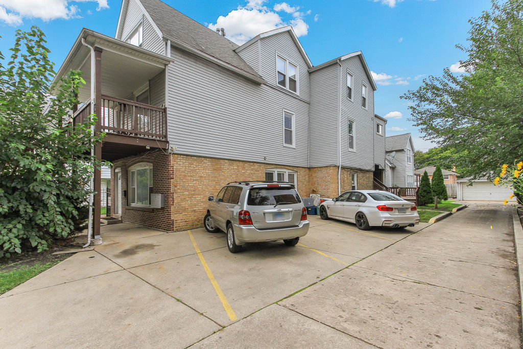 6046 West Giddings Street Chicago, IL 60630 - Photo 2 of 46 a car parked in front of a white building