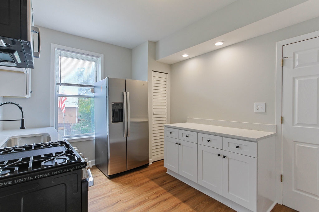 6046 West Giddings Street Chicago, IL 60630 - Photo 21 of 46 a kitchen with white cabinets and appliances