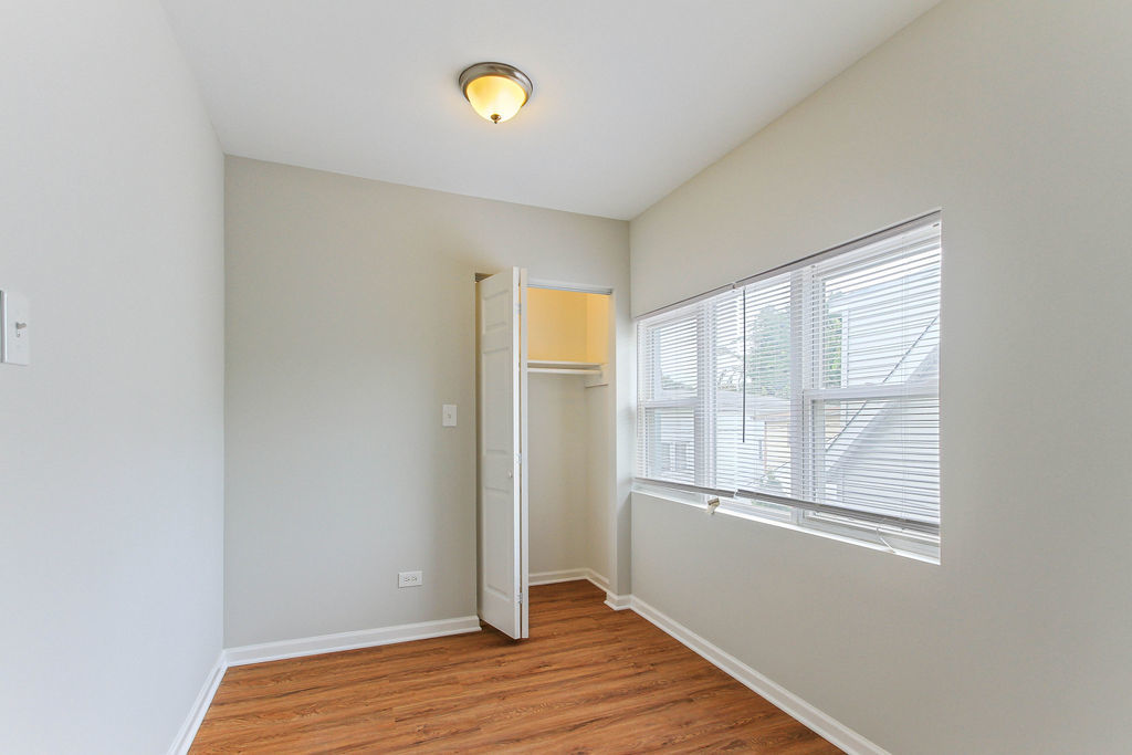 6046 West Giddings Street Chicago, IL 60630 - Photo 22 of 46 a view of an empty room with wooden floor and a window
