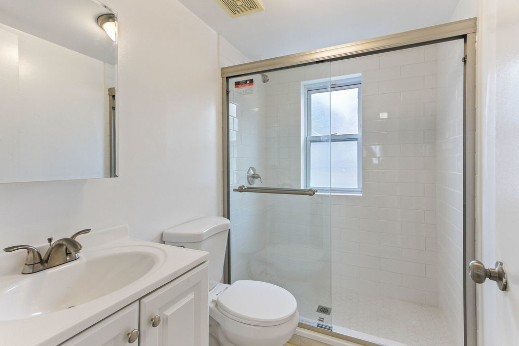 6046 West Giddings Street Chicago, IL 60630 - Photo 34 of 46 a bathroom with a sink a toilet and shower