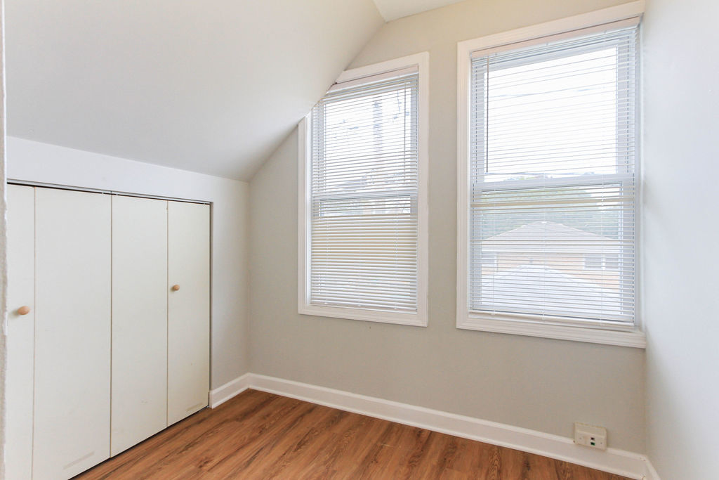 6046 West Giddings Street Chicago, IL 60630 - Photo 35 of 46 a view of an empty room with wooden floor and a window