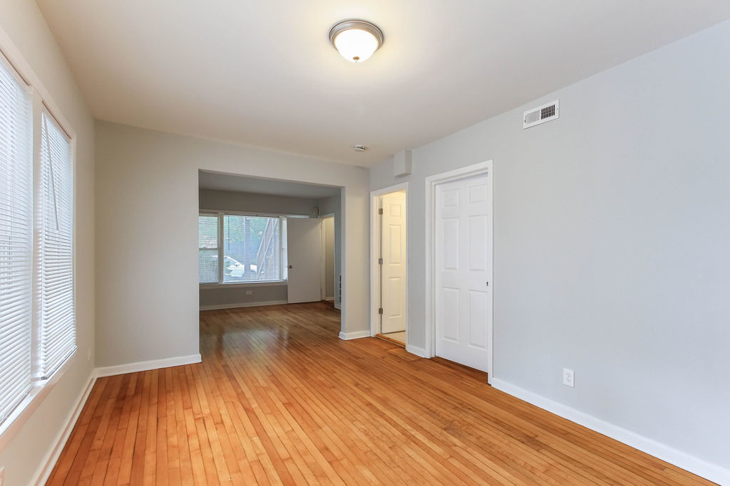 6046 West Giddings Street Chicago, IL 60630 - Photo 4 of 46 wooden floor in an empty room with a window