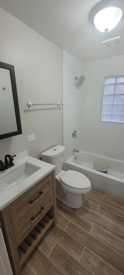 6046 West Giddings Street Chicago, IL 60630 - Photo 46 of 46 a bathroom with a toilet a sink and mirror