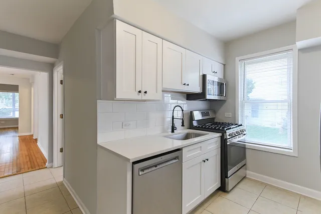 a kitchen with a refrigerator and a sink
