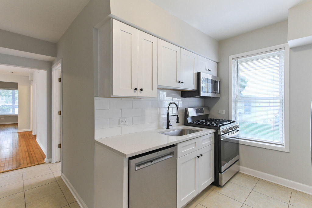 6046 West Giddings Street Chicago, IL 60630 - Photo 6 of 46 a kitchen with stainless steel appliances granite countertop a sink stove and cabinets