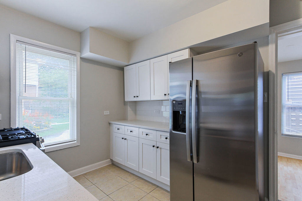 6046 West Giddings Street Chicago, IL 60630 - Photo 7 of 46 a kitchen with a refrigerator and a sink