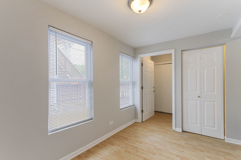 6046 West Giddings Street Chicago, IL 60630 - Photo 8 of 46 an empty room with wooden floor and windows
