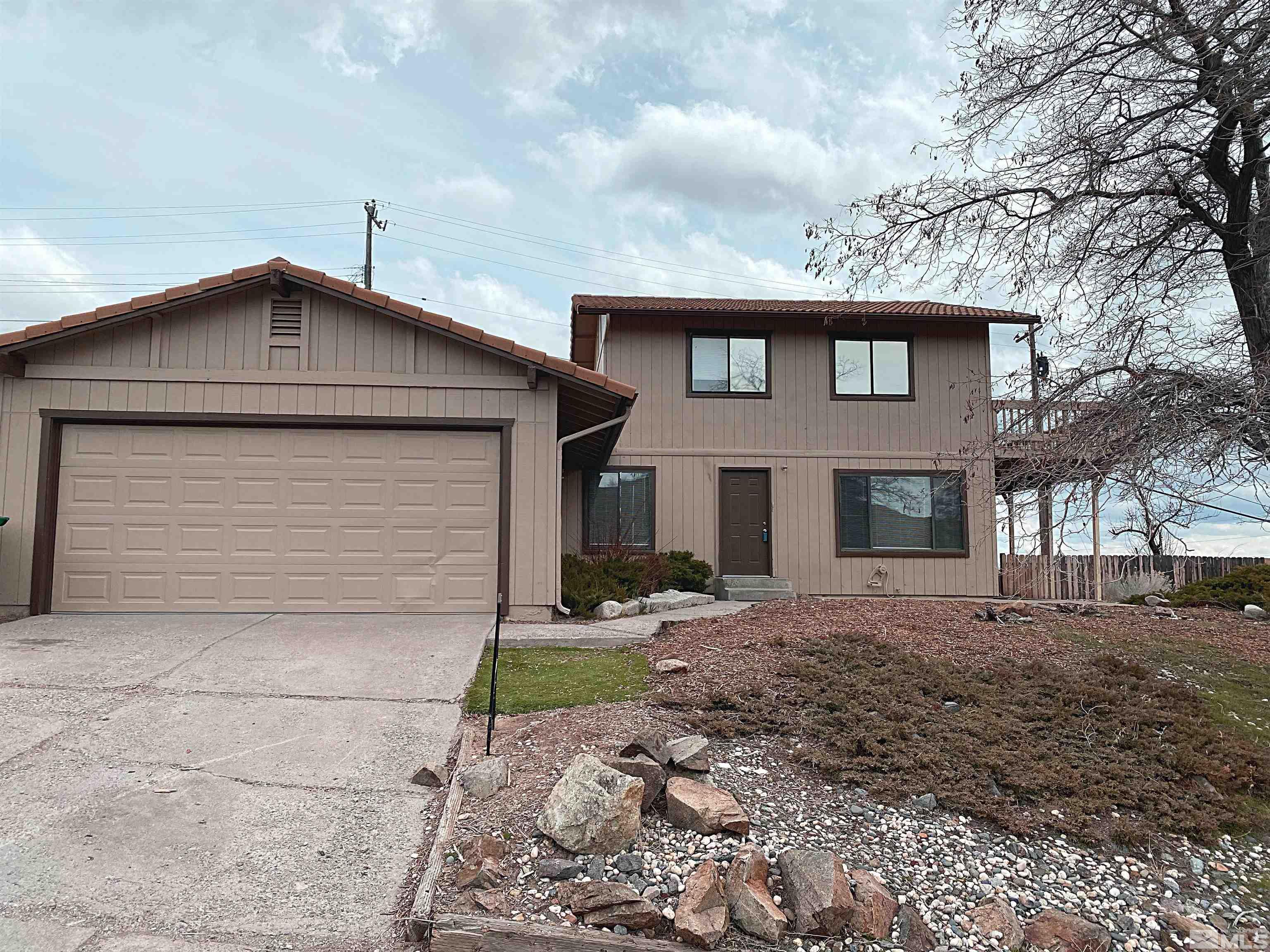 3260 Lodestar Lane Reno, NV 89503 - Photo 1 of 22 a front view of a house with a yard and garage
