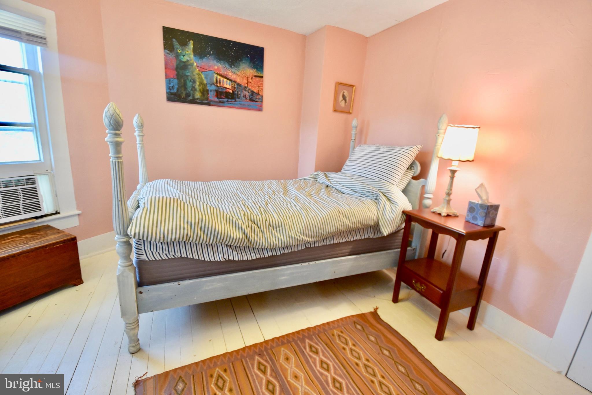 407 Main Street Sharptown, MD 21861 - Photo 13 of 32 a bedroom with a bed and a chair