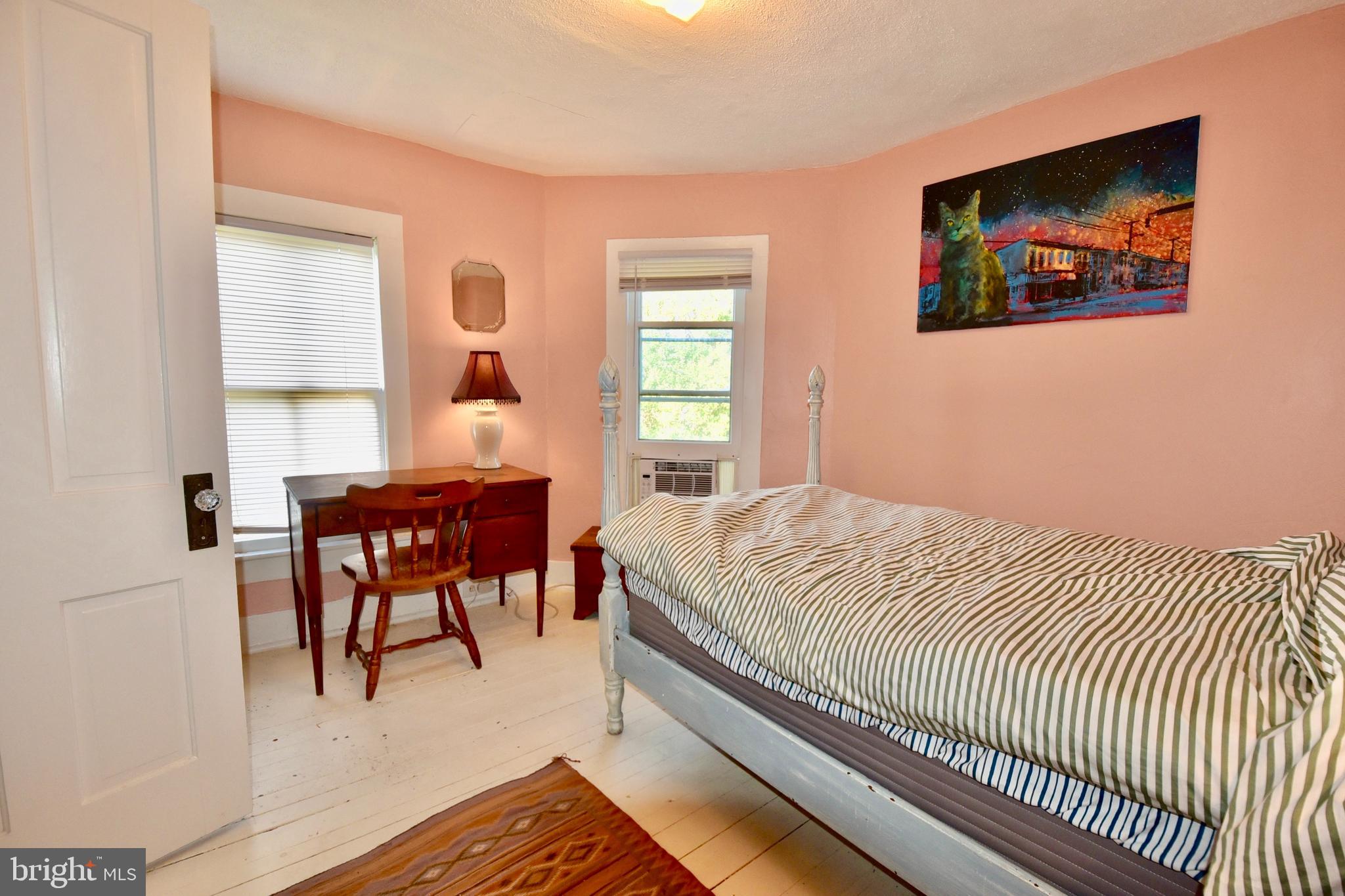 407 Main Street Sharptown, MD 21861 - Photo 14 of 32 a bedroom with a bed and a table with rug