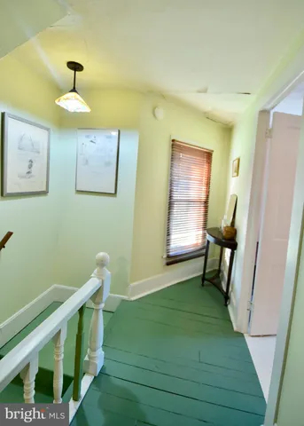 a view of entryway with a window and wooden floor