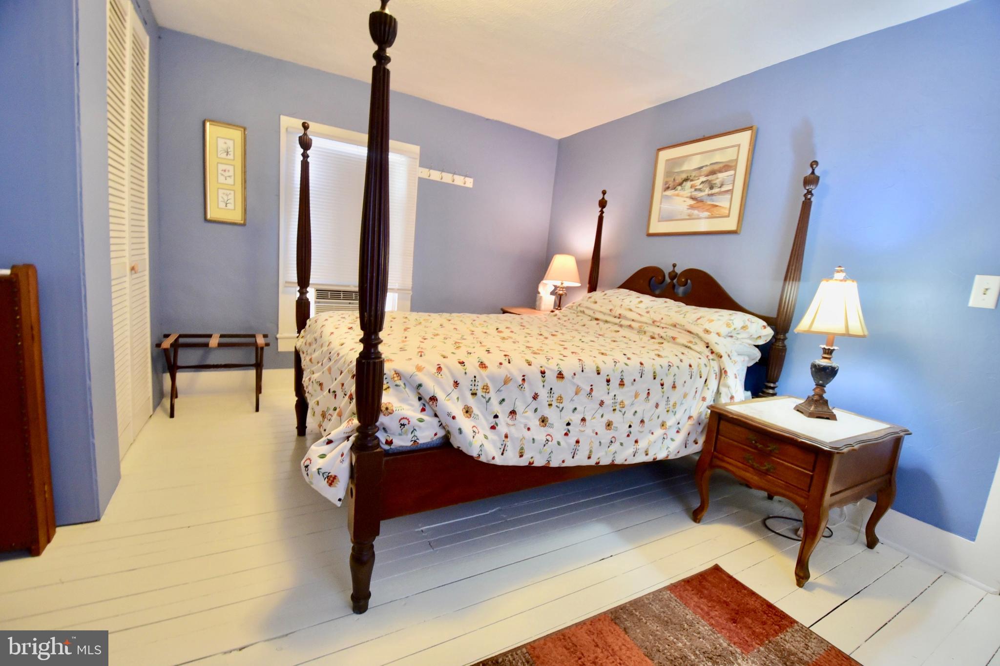 407 Main Street Sharptown, MD 21861 - Photo 19 of 32 a bedroom with bed and a table