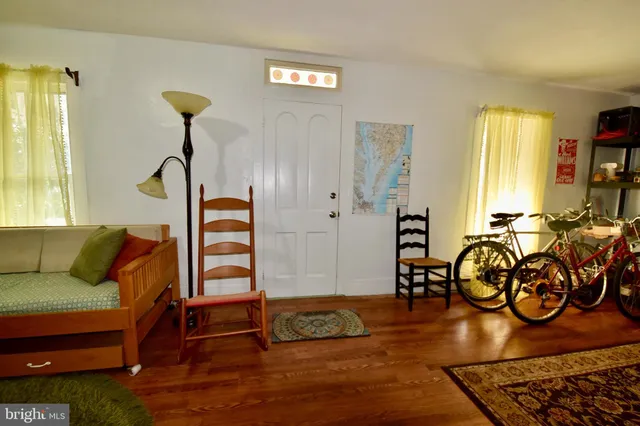 a view of livingroom with furniture staircase and windows