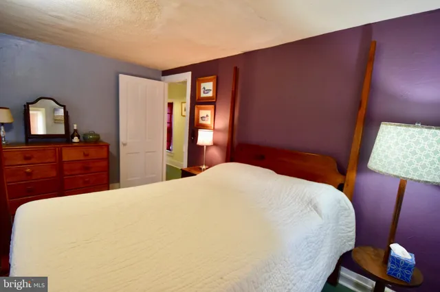 a bedroom with a bed and a dresser