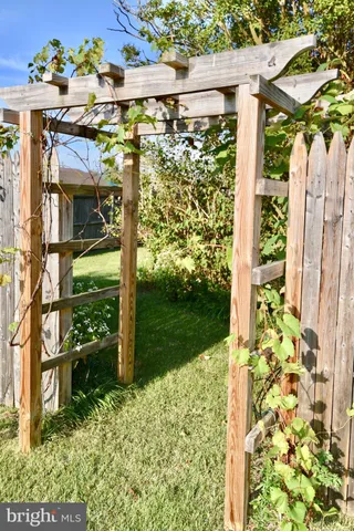 a view of a porch with table and chairs and potted plants