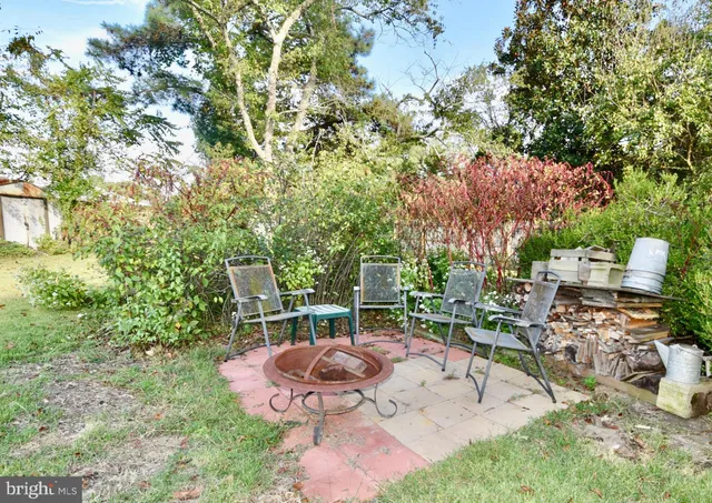 a view of a chairs and table in backyard
