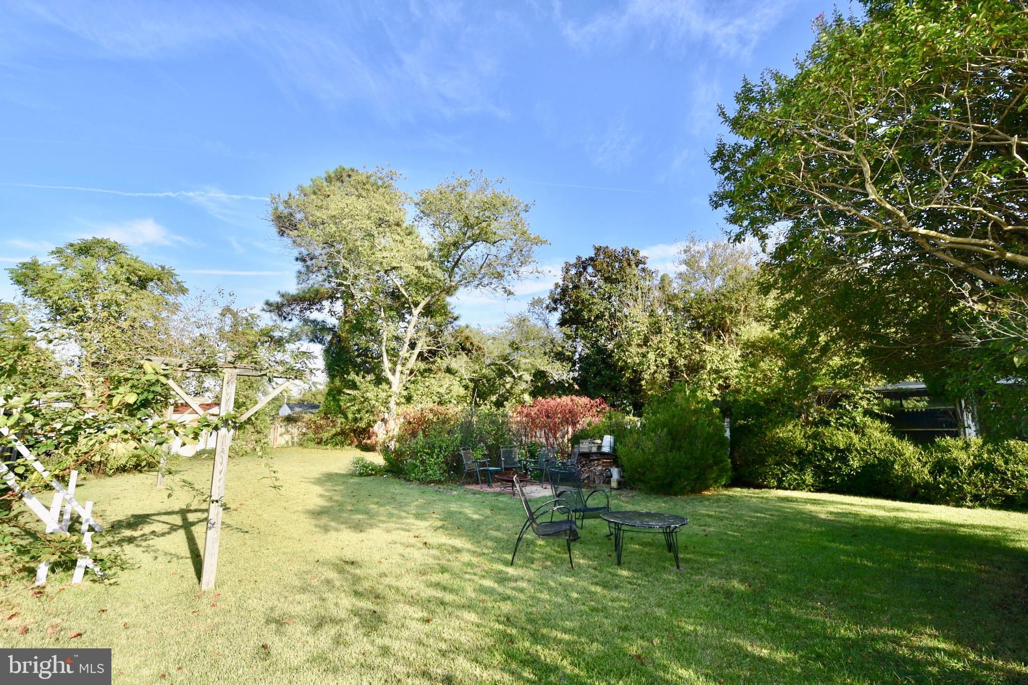 407 Main Street Sharptown, MD 21861 - Photo 27 of 32 a backyard of a house with table and chairs