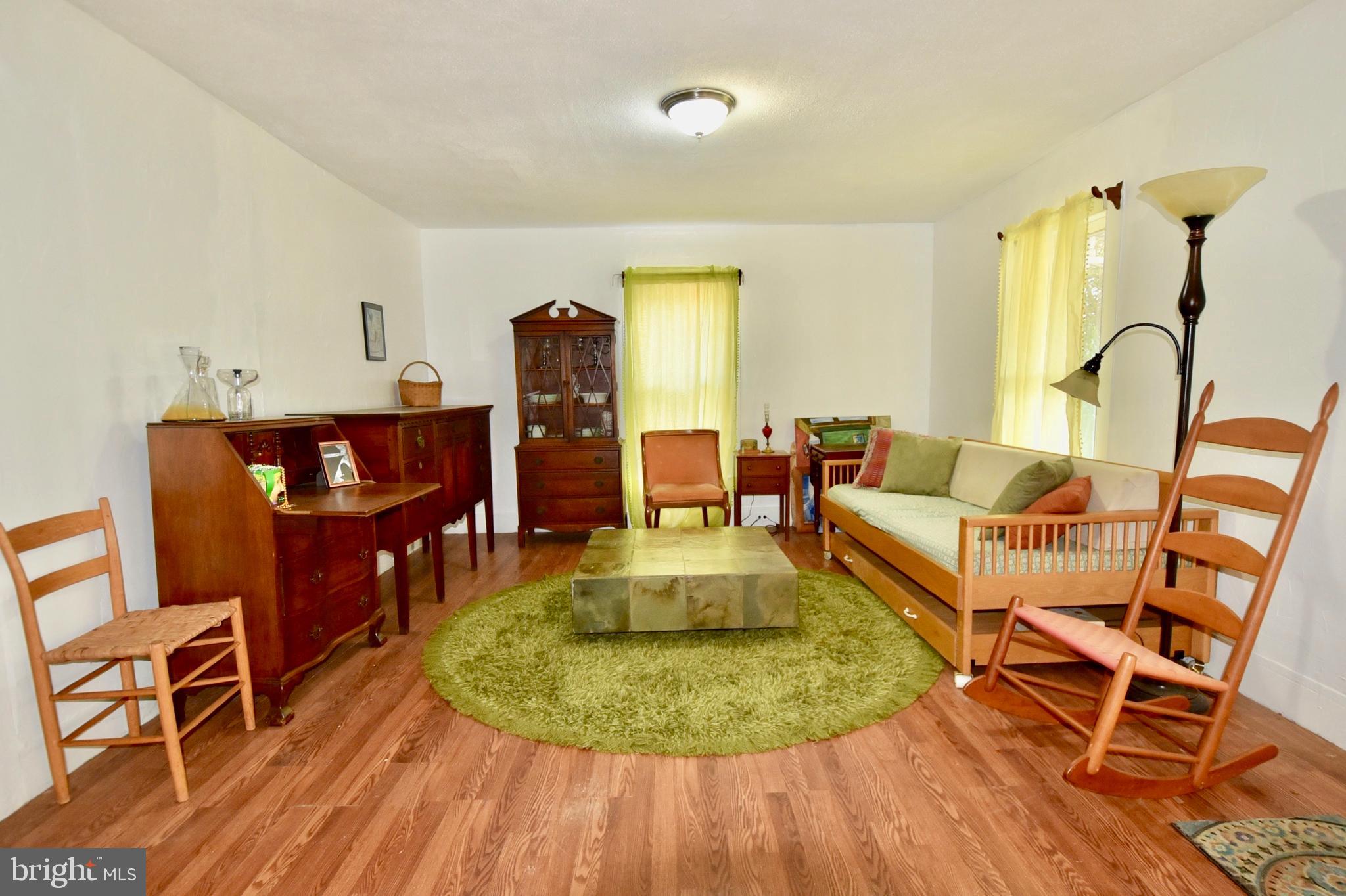 407 Main Street Sharptown, MD 21861 - Photo 4 of 32 a living room with furniture and a wooden floor