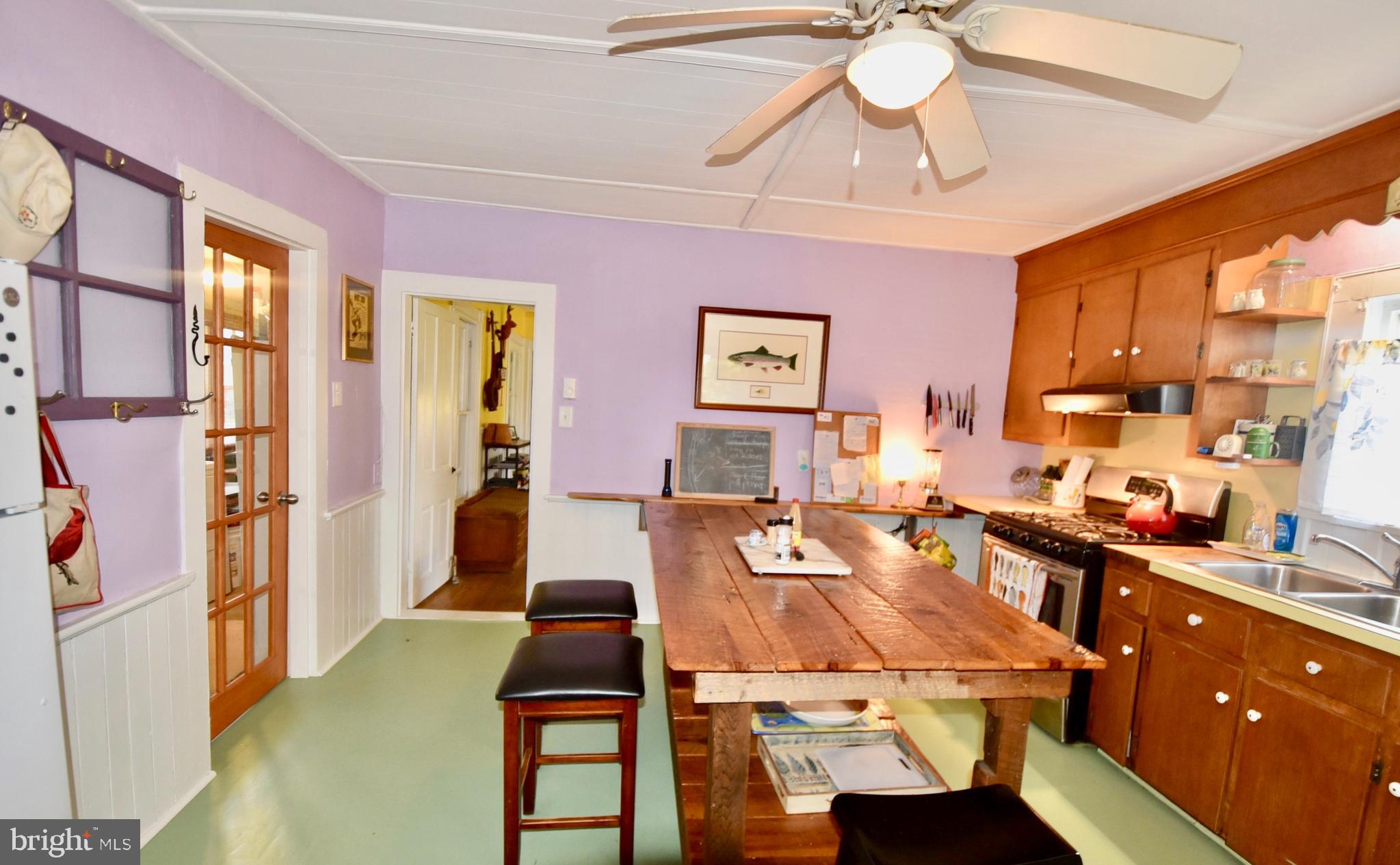 407 Main Street Sharptown, MD 21861 - Photo 5 of 32 a living room with furniture a chandelier and a dining table