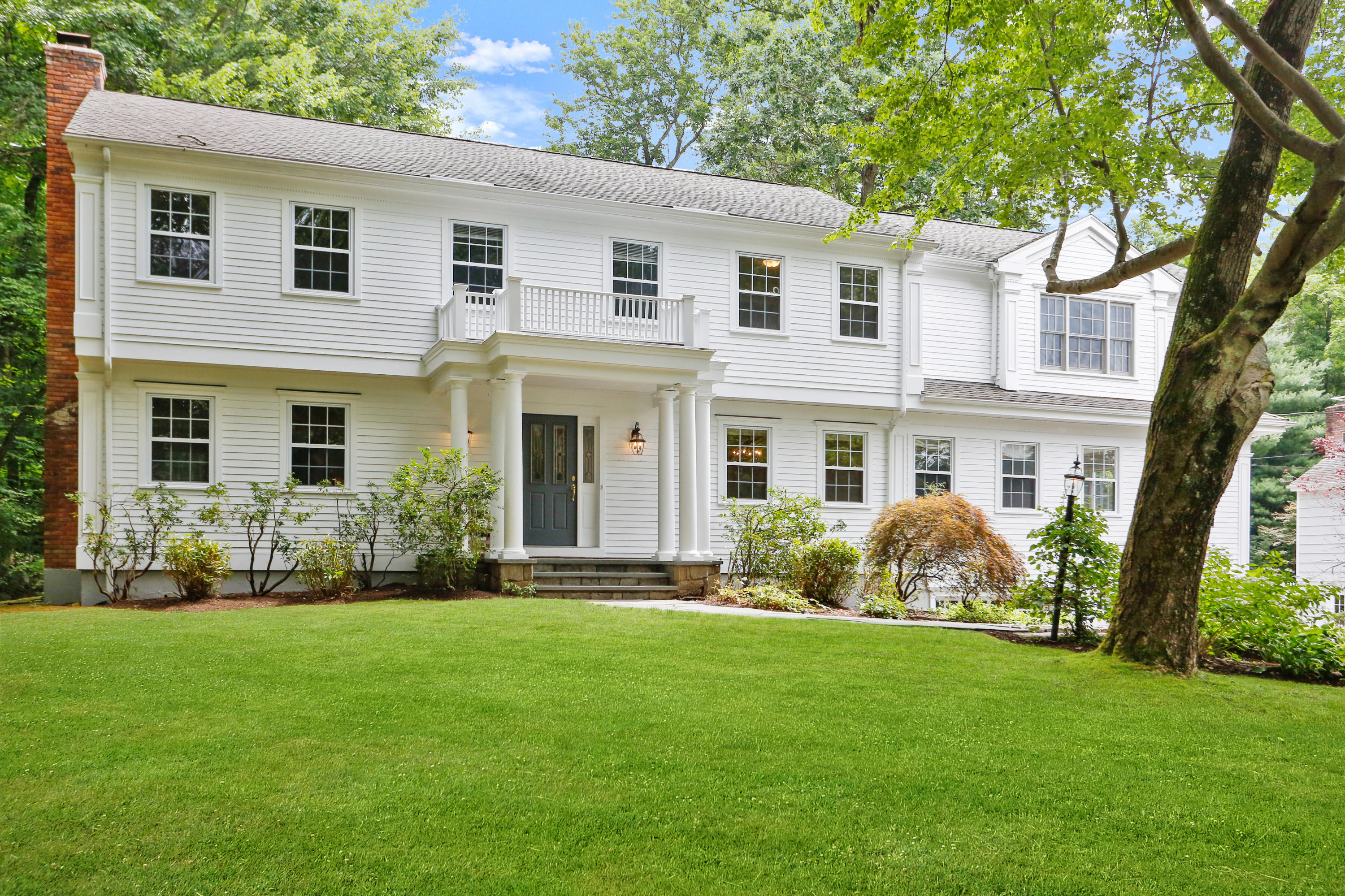 a front view of a house with garden and porch