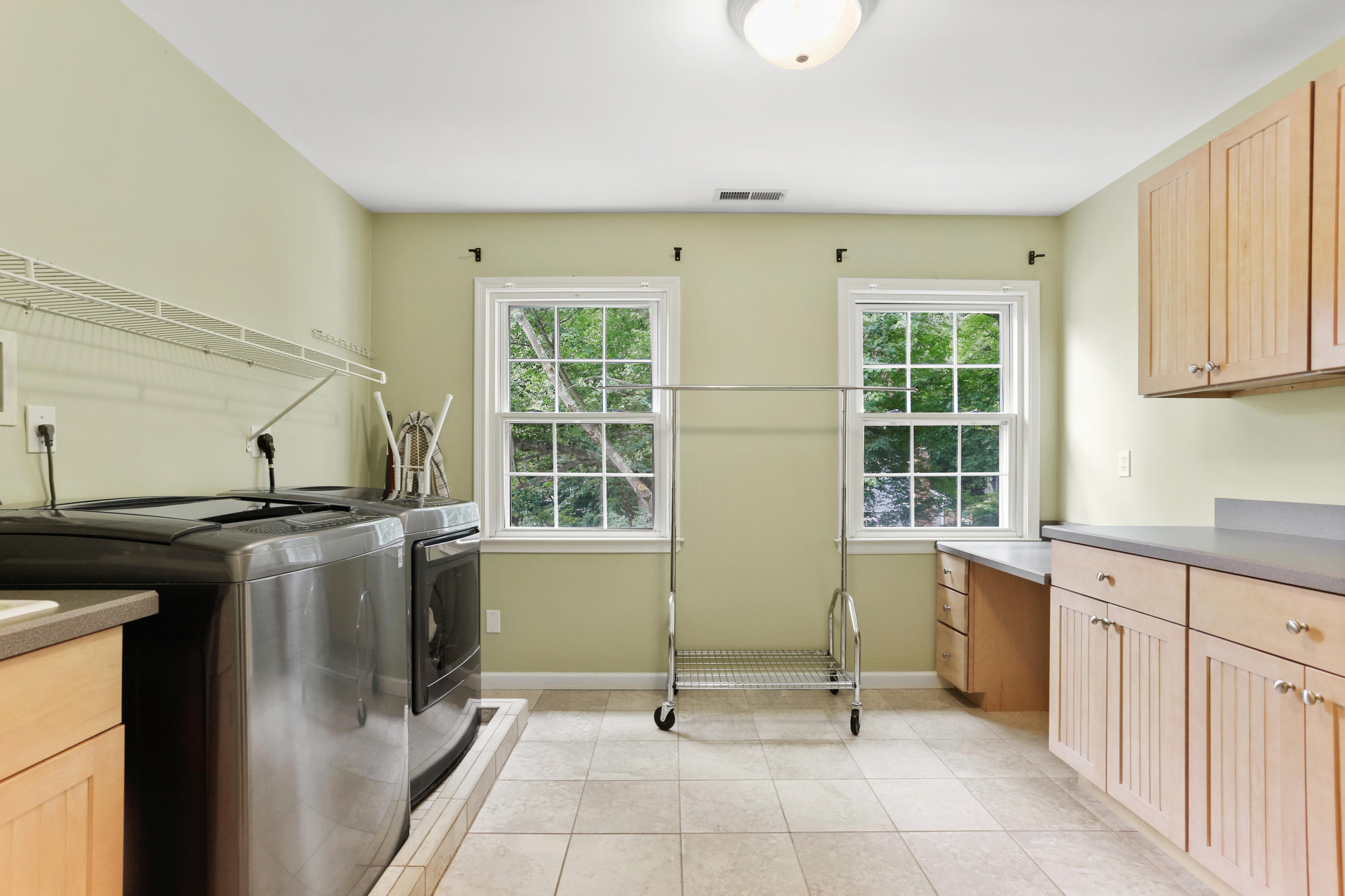 53 Country Club Road Darien, CT 06820 - Photo 18 of 35 a view of a kitchen with a sink wooden cabinets and a window