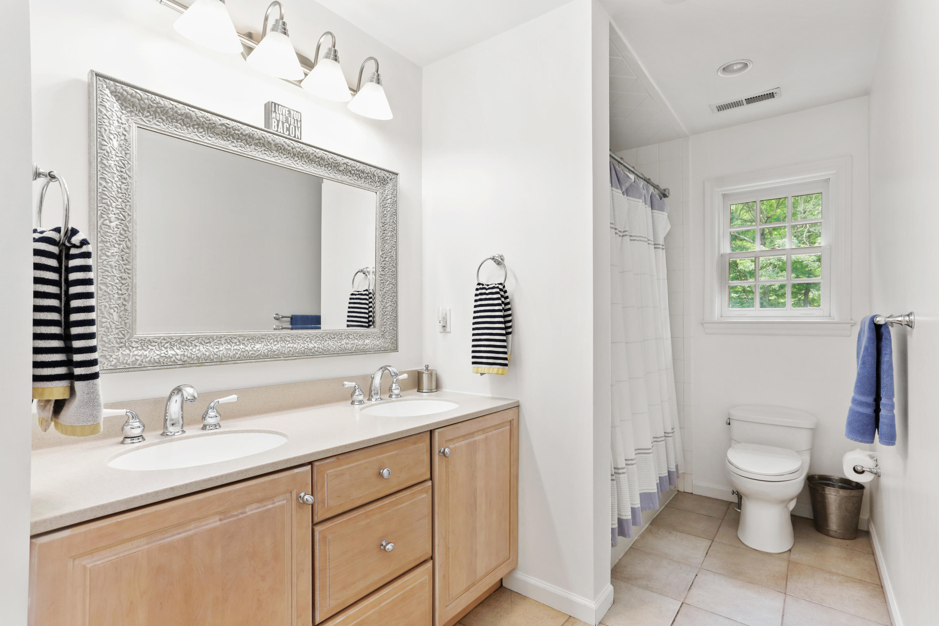53 Country Club Road Darien, CT 06820 - Photo 21 of 35 a bathroom with a toilet sink and mirror