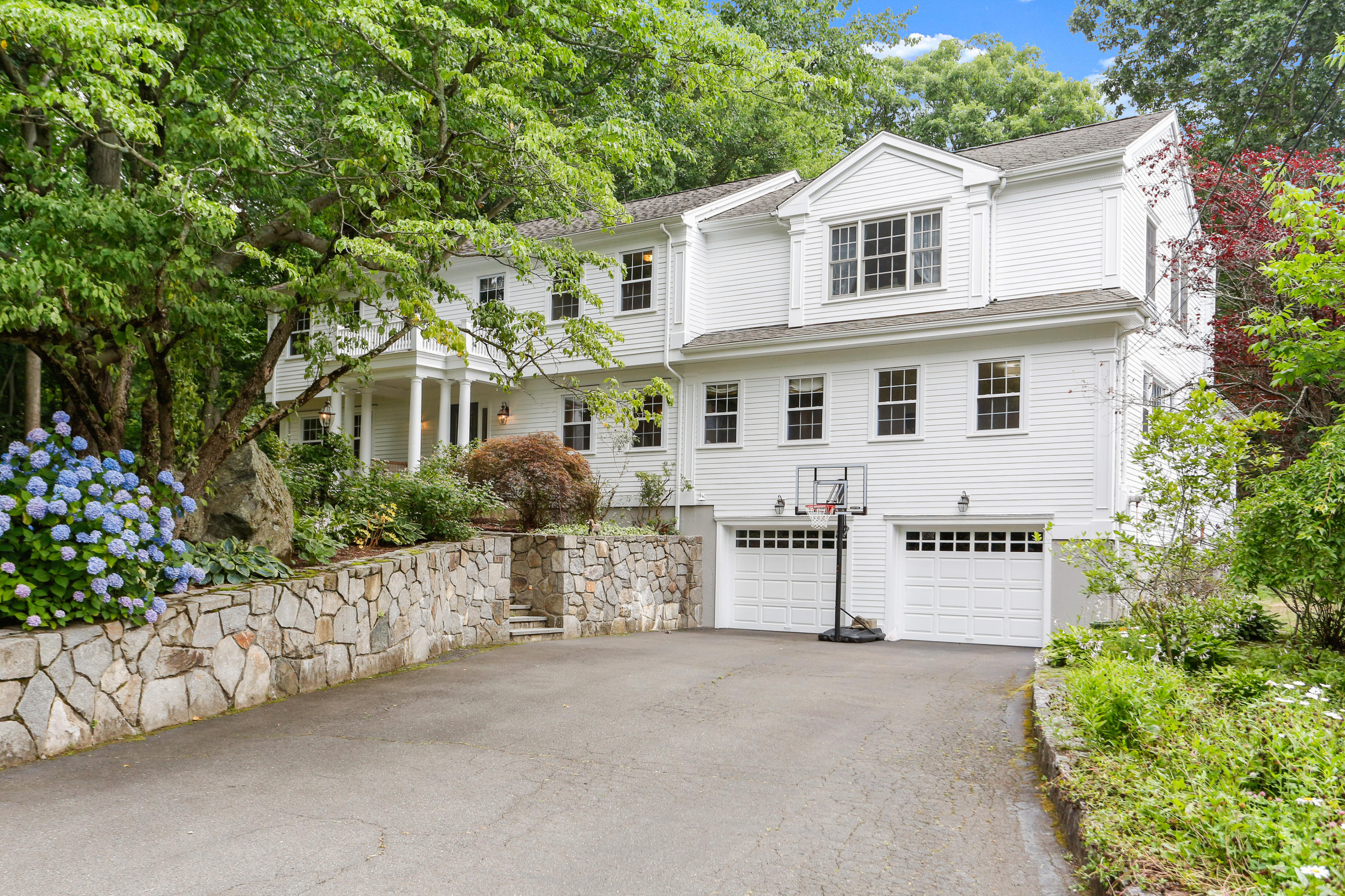 53 Country Club Road Darien, CT 06820 - Photo 30 of 35 a view of a white house with large windows and plants