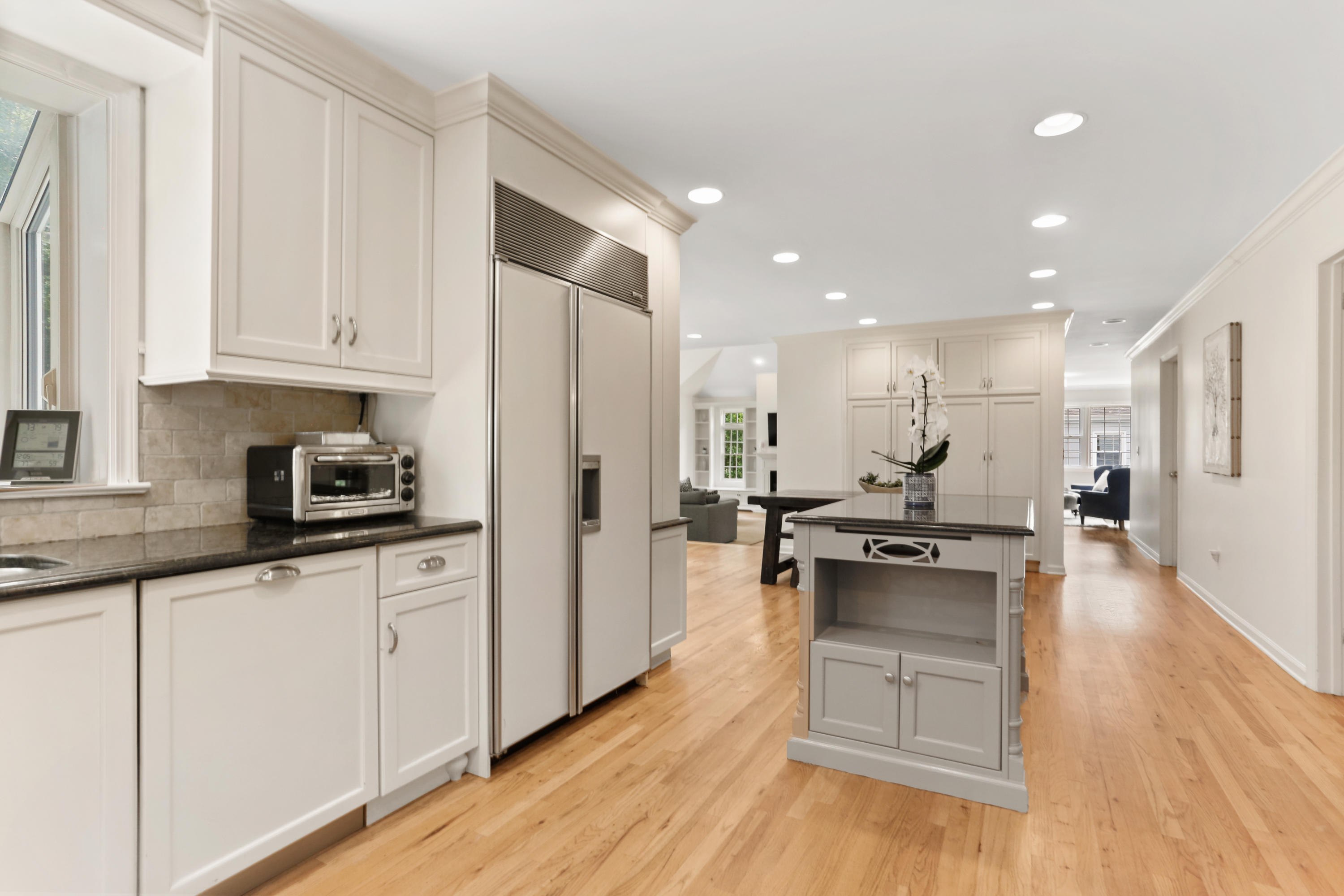 53 Country Club Road Darien, CT 06820 - Photo 10 of 35 a kitchen with stainless steel appliances kitchen island granite countertop a stove a sink a refrigerator and white cabinets with wooden floor