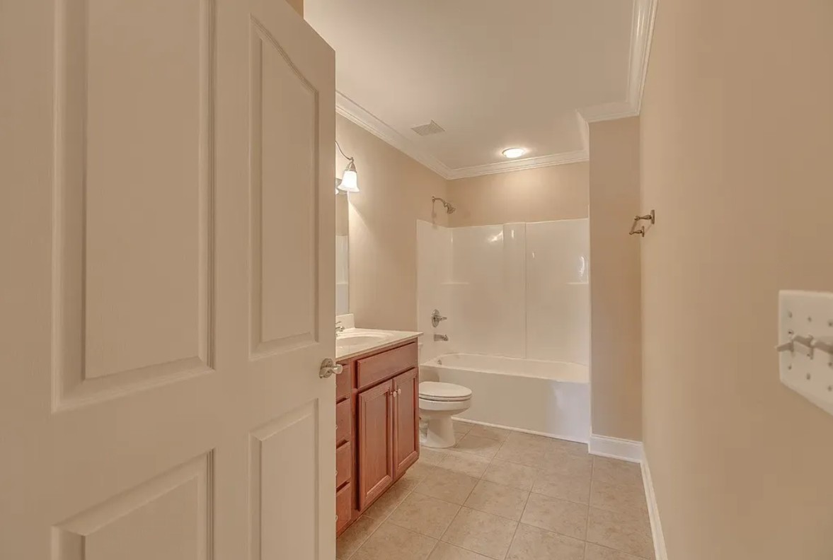 2208 Stanford Court Murfreesboro, TN 37130 - Photo 11 of 18 a bathroom with a granite countertop sink a toilet and shower