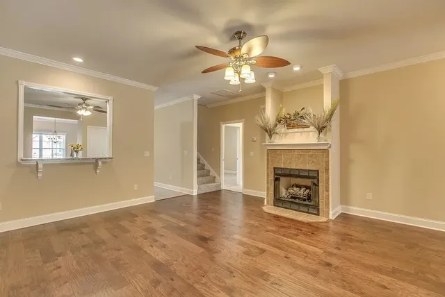 a view of an empty room with a fireplace and a window