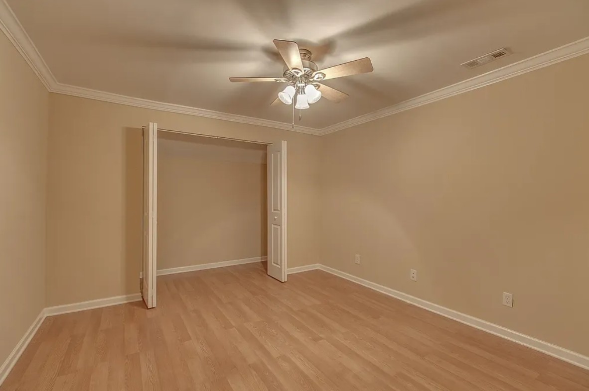 2208 Stanford Court Murfreesboro, TN 37130 - Photo 9 of 18 an empty room with wooden floor fan and windows