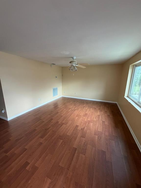 6121 Spring Hill Drive Spring Hill, FL 34606 - Photo 12 of 20 an empty room with wooden floor and windows