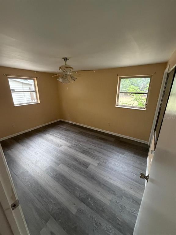 6121 Spring Hill Drive Spring Hill, FL 34606 - Photo 14 of 20 an empty room with wooden floor and windows