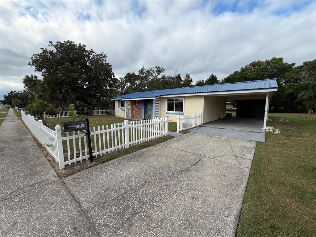 6121 Spring Hill Drive Spring Hill, FL 34606 - Photo 6 of 20 a view of a house with a wooden fence