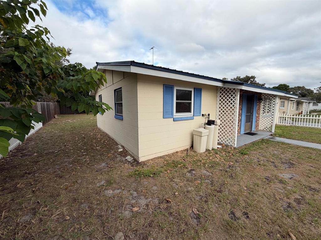 6121 Spring Hill Drive Spring Hill, FL 34606 - Photo 8 of 20 a backyard of a house with garage and garage