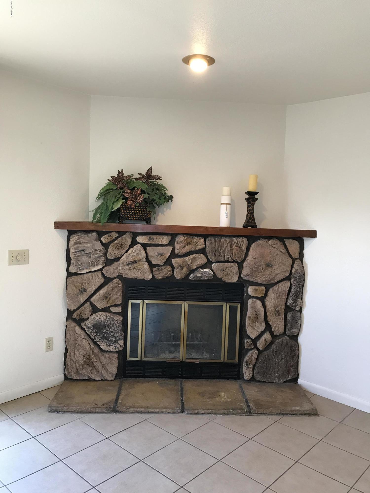 1220 Stetson Road, Unit 4 Prescott, AZ 86303 - Photo 9 of 27 wood burning stone fireplace