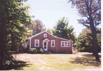 Undisclosed Address Dennis, MA 02638 - Photo 1 of 1 a front view of a house with a yard covered in snow