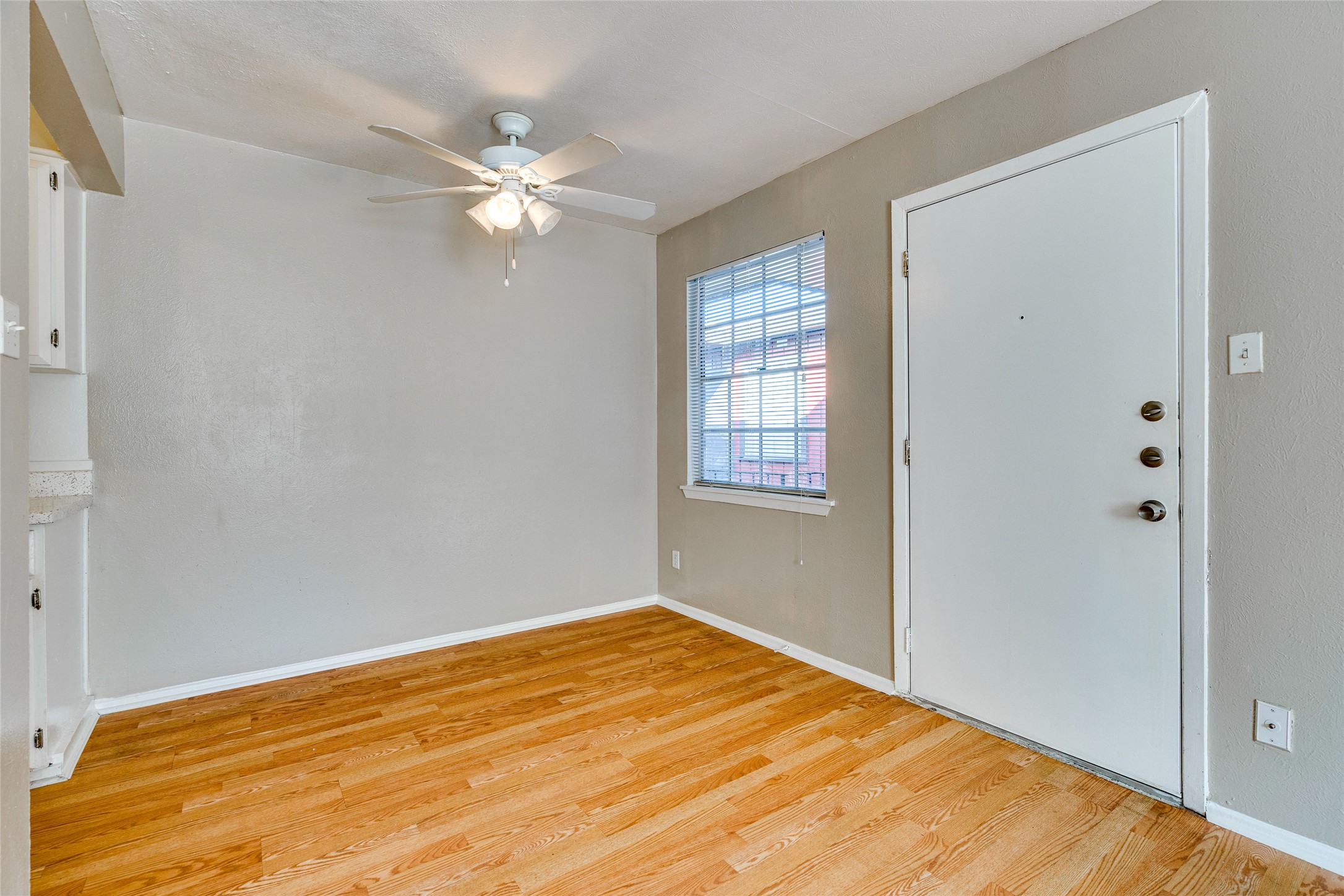 307 East 31st Street, Unit 107 Austin, TX 78705 - Photo 1 of 16 a view of a big room with wooden floor and windows in a room
