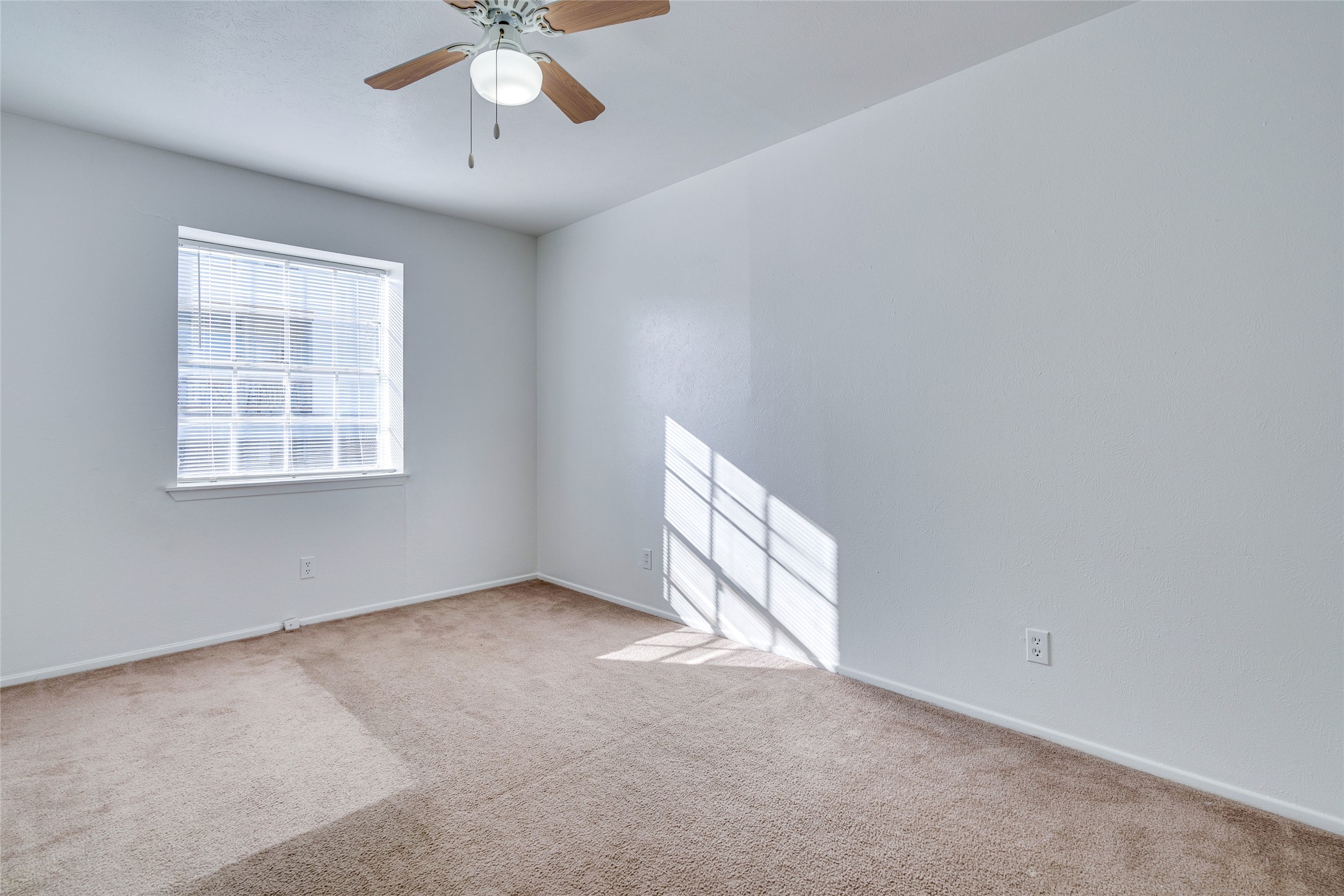 307 East 31st Street, Unit 107 Austin, TX 78705 - Photo 14 of 16 an empty room with a window and a ceiling fan