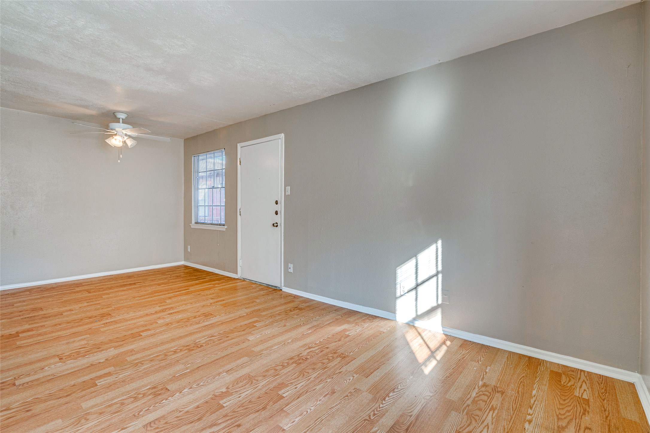 307 East 31st Street, Unit 107 Austin, TX 78705 - Photo 5 of 16 a view of empty room with wooden floor and fan