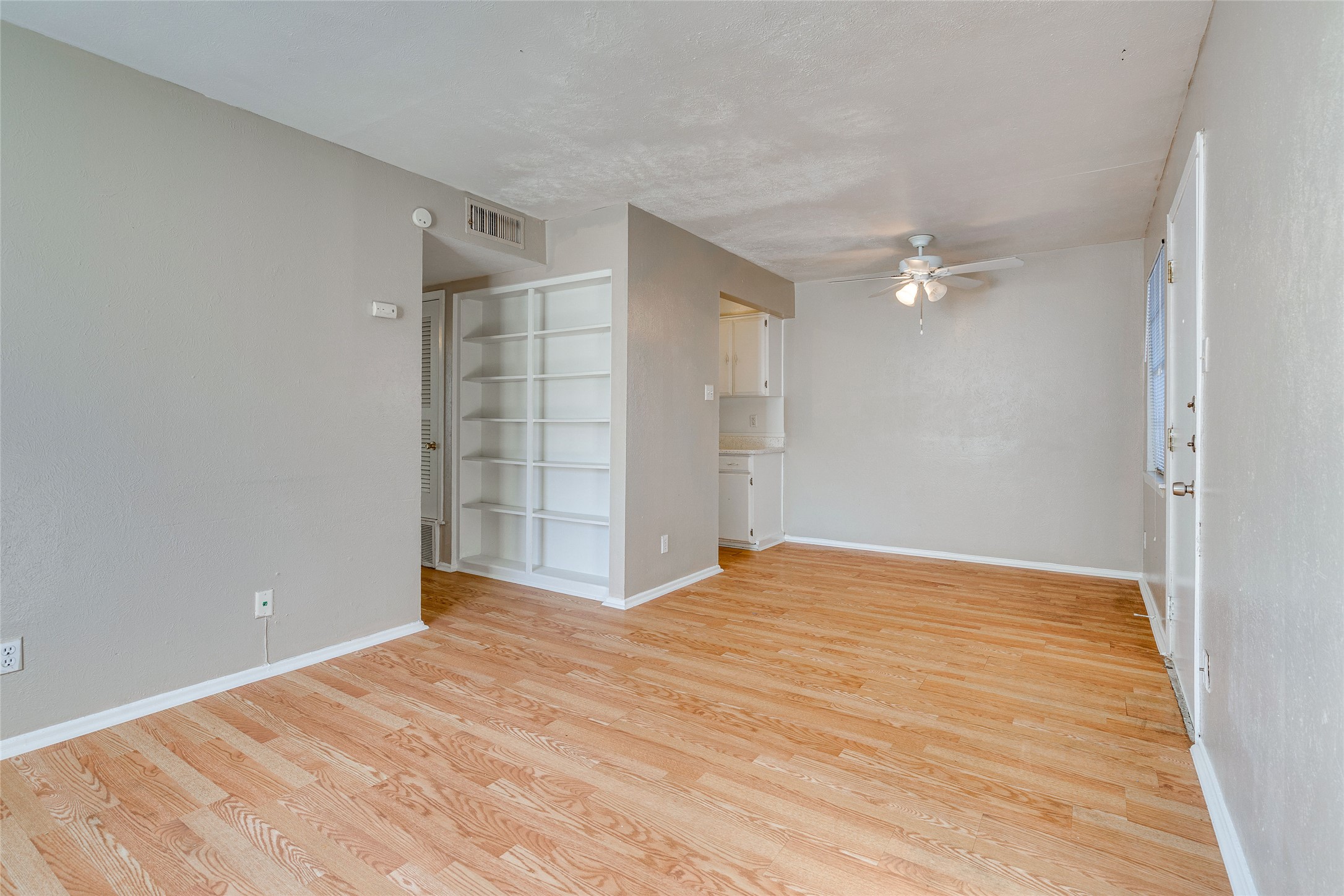 307 East 31st Street, Unit 107 Austin, TX 78705 - Photo 6 of 16 a view of an empty room with wooden floor